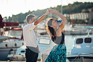 Romantic couple dancing on the street. Having a romantic date. Celebrating anniversary. Valentines day. Birthday date