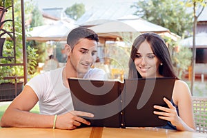 Romantic Couple on a Date Holding Restaurant Menu