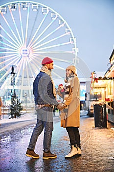 Romantic couple dating at ferris wheel in winter