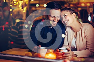 Romantic couple dating in pub at night