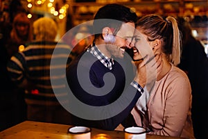 Romantic couple dating in pub at night