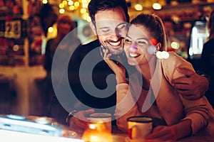 Romantic couple dating in pub at night