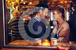 Romantic couple dating in pub at night