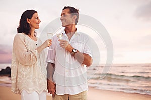 Romantic Couple Drinking Champagne on the Beach at Sunset