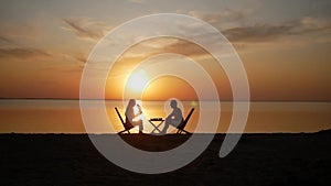 Romantic Couple Drinking At Sunset Near The Sea, Two People In Love.