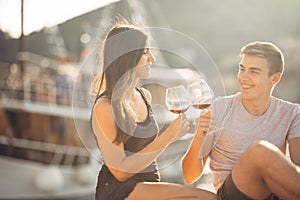 Romantic couple drinking wine at sunset.Romance.Two people having a romantic evening with a glass of wine near the sea.Cruise ship