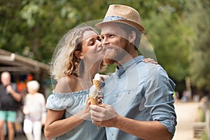 romantic couple eating ice cream at park