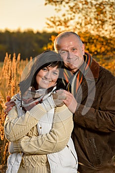 Romantic couple embracing in autumn sunset park