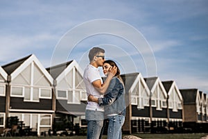 Romantic couple in embrance stand on building background