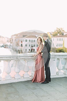 Romantic couple enjoying evening in Venice. Romantic travel couple in Venice on travel vacation holidays. Italy, Europe.