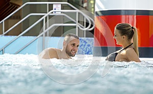 Romantic couple enjoying thermal bath spa and wellness center