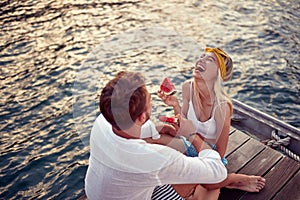 Romantic   couple enjoys by the lake. Beautiful summer day