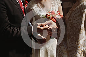 Romantic couple exchanging rings during wedding ceremony in chur