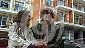 Romantic couple feeling happy outdoor. Man and woman laughing on urban street.