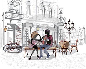 Romantic couple with a guitar sitting on the bench in the old city