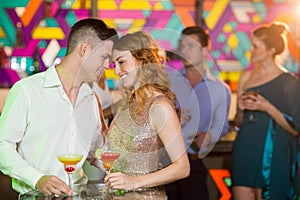 Romantic couple having glass of cocktail