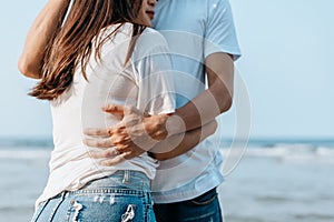 Romantic couple having love and hug on the beach