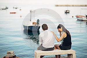 Romantic couple having relationship problems.Woman crying and begging a man.Fisherman life,dangerous occupation.Navy sailors photo