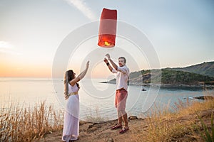 Romantic couple holding fire lanter