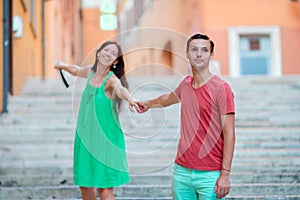 Romantic couple holding hands on Steps in Rome enjoy italian holidays. Happy lovers walking on the travel landmark