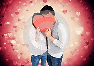 Romantic couple holding heart shape and kissing each other