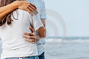 Romantic couple hug together on the beach at summer. Honeymoon, travel, holiday, summer concept