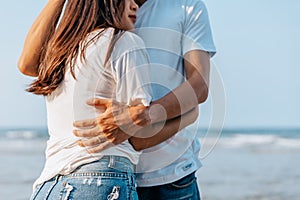 Romantic couple hug together on the beach at summer. Honeymoon, travel, holiday, summer concept