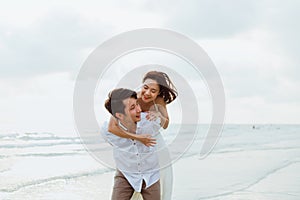 Romantic couple hug together on the beach at summer. Honeymoon, travel, holiday, summer concept