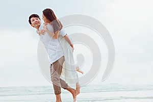 Romantic couple hug together on the beach at summer. Honeymoon, travel, holiday, summer concept