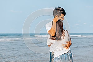 romantic couple hug together on the beach at summer. Honeymoon  travel  holiday  summer concept