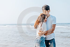 Romantic couple hug together on the beach at summer. Honeymoon, travel, holiday, summer concept