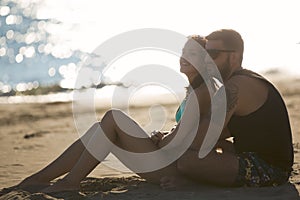 Romantic couple in hug watching sunrise/ sunset together.Young man and woman in love