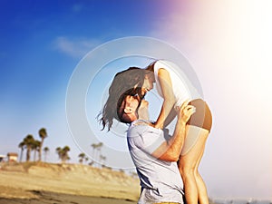 Romantic couple in intimate moment on the beach. photo