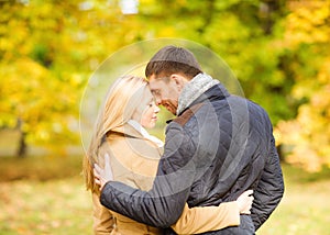Romantic couple kissing in the autumn park