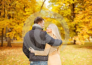 Romantic couple kissing in the autumn park