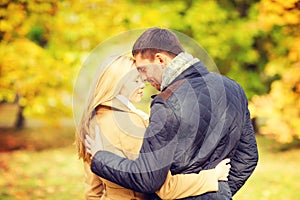 Romantic couple kissing in the autumn park