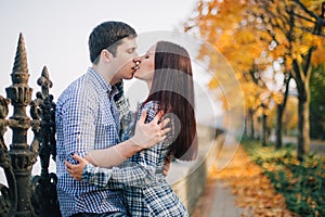 Romantic couple kissing in autumn park