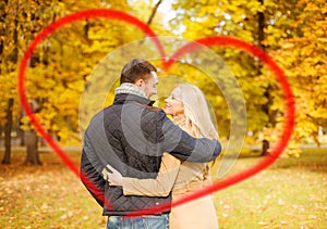 Romantic couple kissing in the autumn park