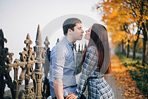 Romantic couple kissing in autumn park