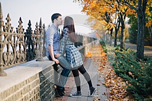 Romantic couple kissing in autumn park