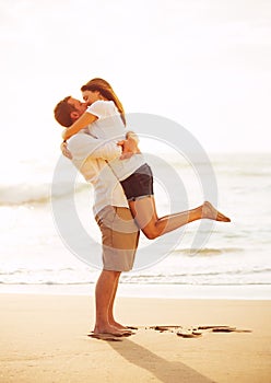 Romantic Couple Kissing on the Beach at Sunset