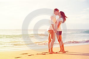 Romantic Couple Kissing on the Beach at Sunset