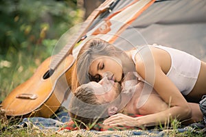 Romantic couple kissing on an camp near tent. Kissing lovers. Picnic couples. photo