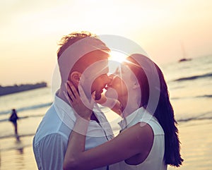 Romantic couple kissing on a hot, tropical beach