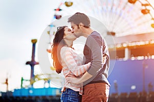 Romantic couple kissing infront of santa monica