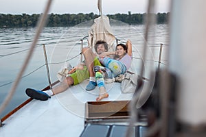 Romantic couple lies on a yacht