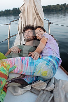 Romantic couple lies on a yacht
