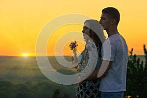 Romantic couple look on sun, evening on outdoor, beautiful lands