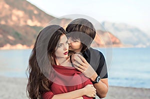 Romantic couple in love at beach sunset. Newlywed happy young lo