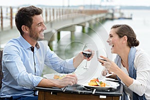 Romantic couple in love having dinner at sea beach restaurant